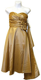 item p062. Strapless Bust Pleged Short Cocktail Dress. Short strapless cocktail dress with emphasis on bust and shirred waist for a slimmer look. Skirt with bow on one side. Dress made of taffeta fabric. Color Shown: Gold (unavailable).